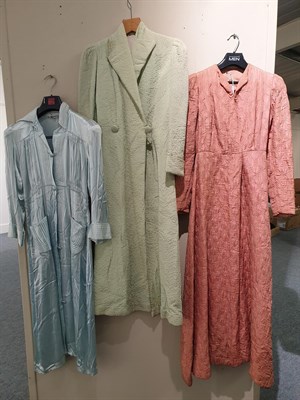 Lot 6141 - Circa 1930s/40s Ladies' Day and Night Robes comprising a silver coloured long sleeved silk robe...