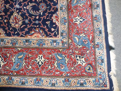 Lot 1263 - A Modern Persian Wool Rug, the indigo field with a mesh of stylised lotus and tendrils within a...