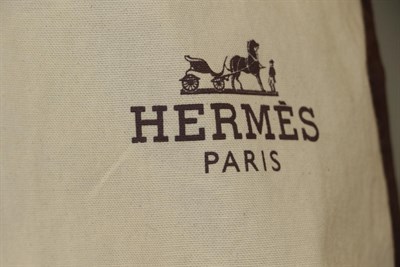 Lot 6209 - A Hermes Dark Taupe Ladies' Coat, with button fastening, side pockets, collar (size 38); with a...