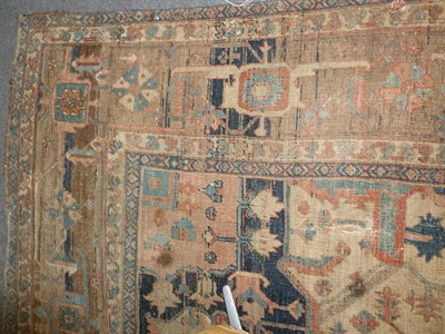 Lot 1268 - Heriz Carpet  Persian Azerbaijan The abrashed madder field of angular vines around an indigo...