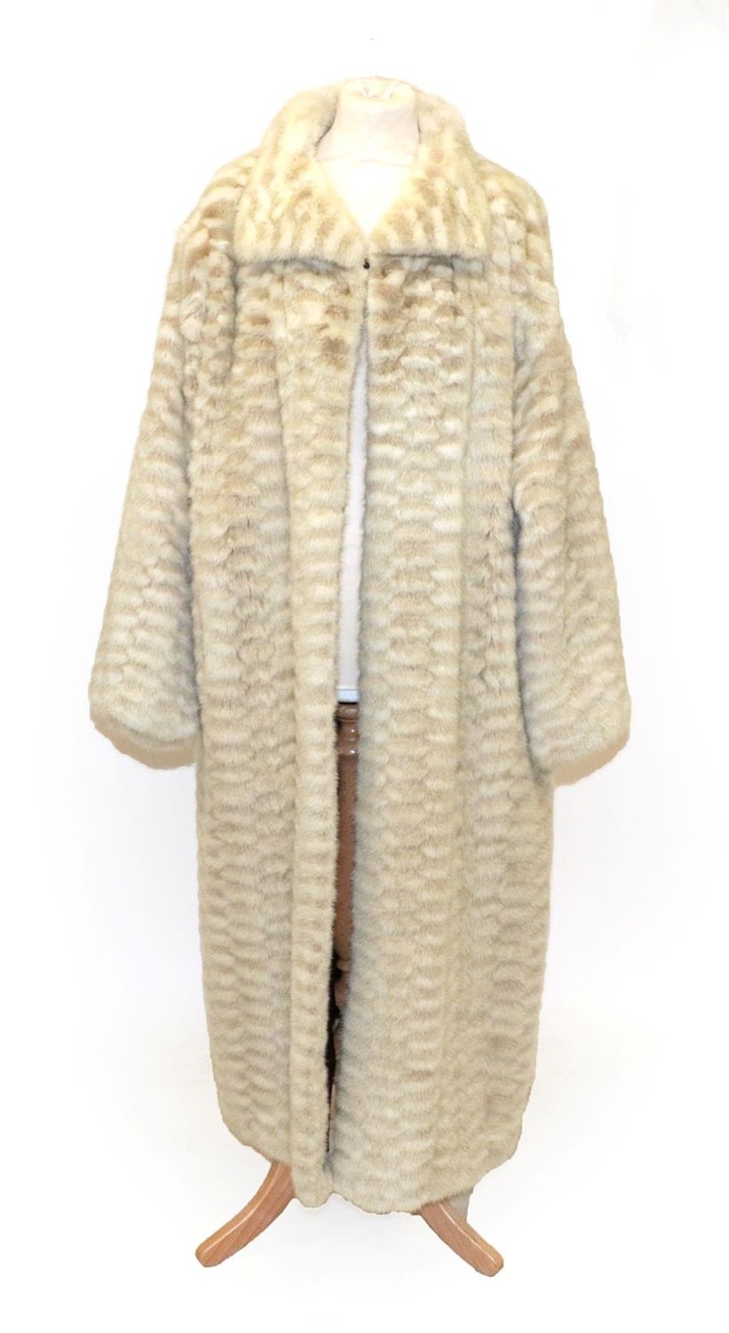 Lot 6218 - A Cream and Light Grey Checked Mink Long Coat, with slit pockets, the burgundy lining...