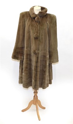 Lot 6234 - Grosvenor Canada at Harrods Long Coat, with three large fur mounted buttons, tiered panels to...