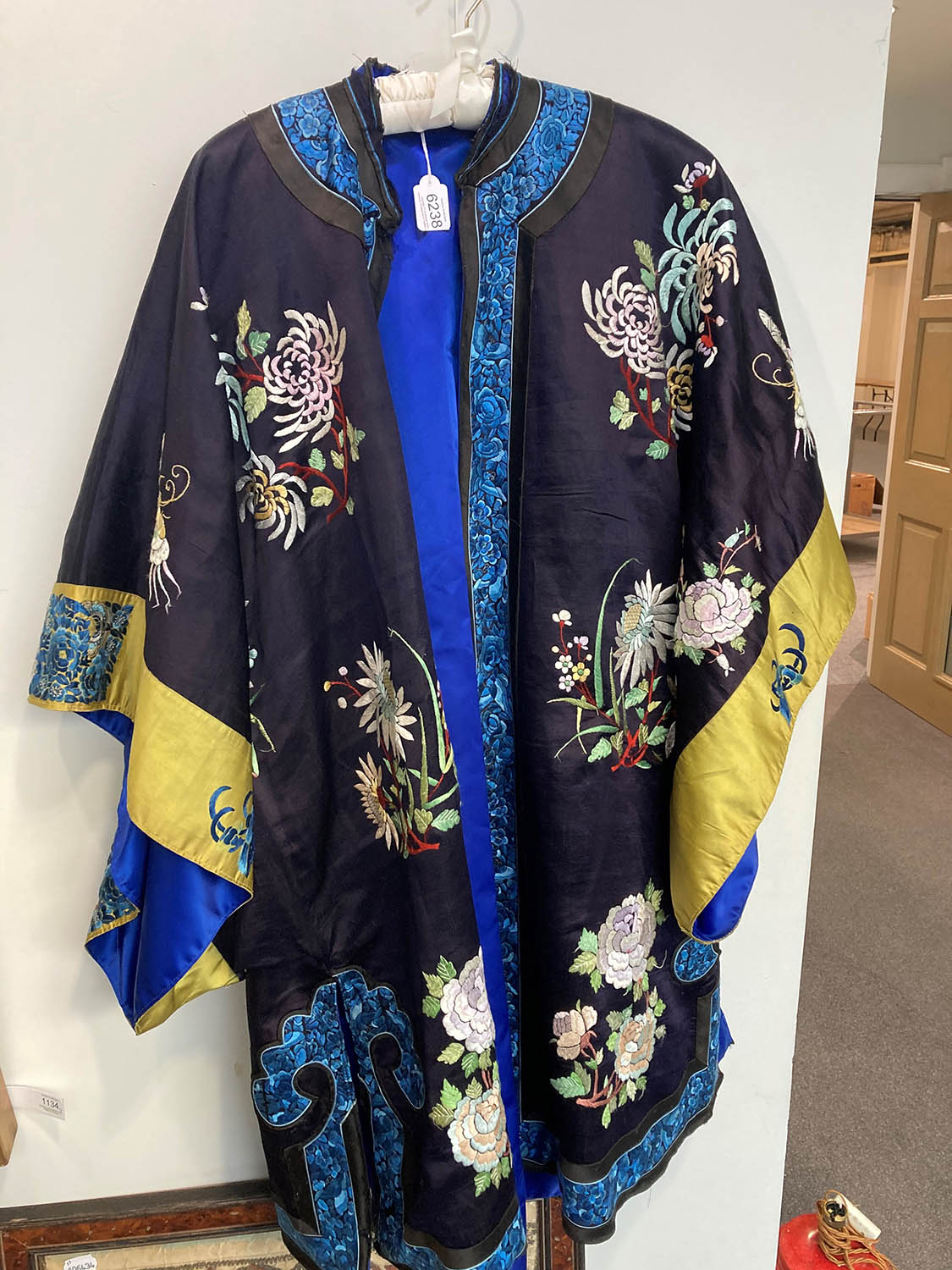 Lot 6238 - Early 20th Century Chinese Navy Silk Jacket, embroidered with chrysanthemums and butterflies in...