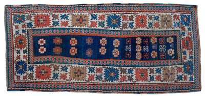 Lot 1272 - Moghan Long Rug South East Caucasus The deep indigo abrashed field with tribal motifs enclosed...