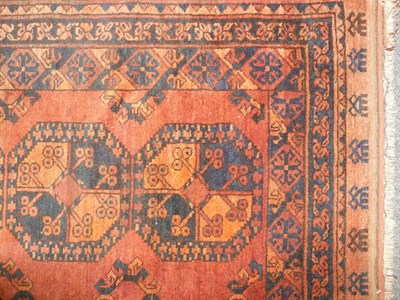 Lot 1275 - Afghan Rug Afghan Turkestan The soft madder field with two columns of elephant foot guls...