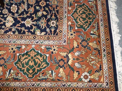 Lot 1281 - Indian Carpet The deep indigo field of palmettes and vines enclosed by wide terracotta borders,...