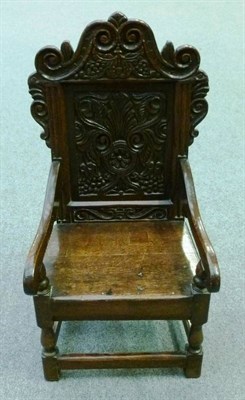 Lot 1282 - A Child's Carved Wainscot Type Chair, with S scroll carved top rail above a lunette and flower...