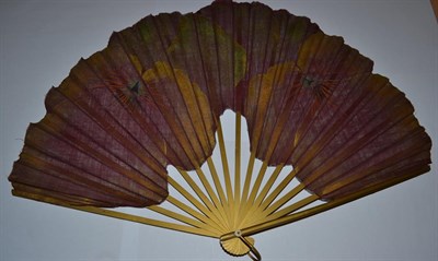 Lot 5040 - A Dramatic Fan, the leaf in aubergine cotton, shaped and cut away to follow the form of blousy...