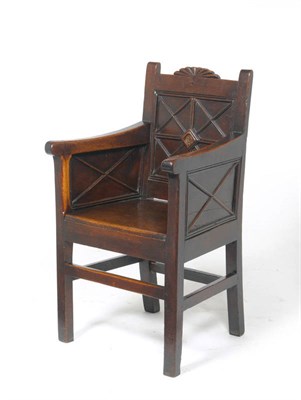 Lot 1287 - A Joined Oak Enclosed Armchair, probably Early 19th Century, with panel back support and sides, the