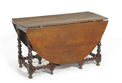 Lot 1294 - A Late 17th Century Oak Eight-Seater Gateleg Table, the rectangular top with two rounded drop...