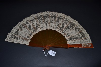 Lot 5129 - A Late 19th Century Brussels Lace Fan, the Point de Gaze needle lace leaf mounted on resin or...