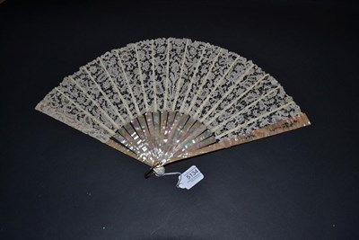 Lot 5134 - A Large Circa 1900 Pink Mother-of-Pearl Fan, the monture lightly carved and slightly pierced,...