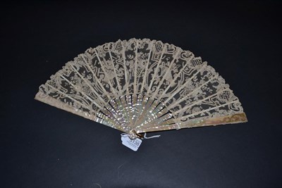 Lot 5138 - An Unusual Lace 19th Century Brussels Point De Gaze Lace Fan, the monture a soft pink...