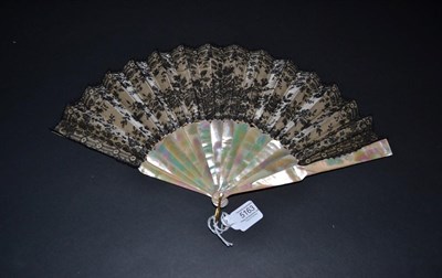 Lot 5163 - Circa 1860's A Black Chantilly Lace Fan backed with cream silk, and mounted on green/pink...