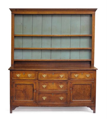 Lot 1299 - A George III Oak and Mahogany Crossbanded Enclosed Tall Dresser, late 18th century, the dentil...