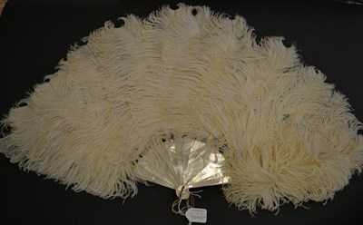 Lot 5174 - Two Ostrich Feather Fans, one from the late 19th century with white plumes, the other early...