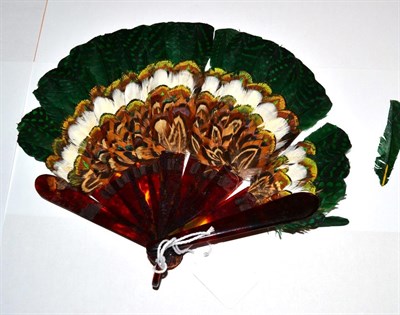 Lot 5178 - A Small Faux Tortoiseshell Feather Fan, most likely game bird feathers collected by the hunting...