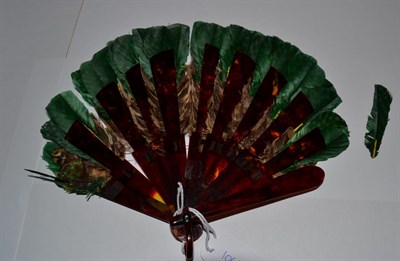 Lot 5178 - A Small Faux Tortoiseshell Feather Fan, most likely game bird feathers collected by the hunting...