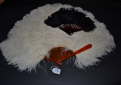 Lot 5183 - A Large Frothy White Ostrich Feather Fan, mounted on blonde tortoiseshell or resin, the upper guard