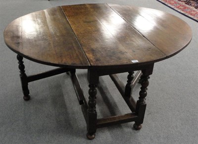 Lot 1304 - An Early 18th Century Oak Eight-Seater Gateleg Dining Table, on eight turned and block legs,...