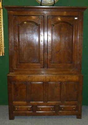 Lot 1305 - An 18th Century Joined Oak Press Cupboard, the bold cornice above conforming arched fielded...