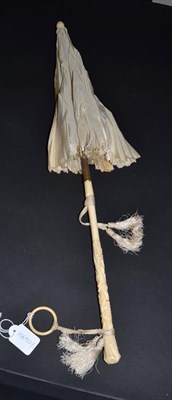 Lot 5246 - A Mid-19th Century Folding Parasol, the cover in cream silk with scalloped edges. The handle,...