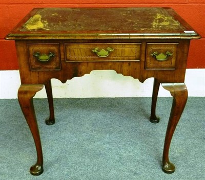 Lot 1307 - A George I Walnut Dressing Table, circa 1720, the rectangular moulded top above one long and...