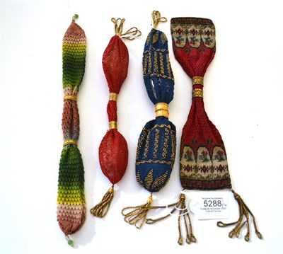 Lot 5288 - Four Attractive Miser's or Stocking Purses, mid-19th century, comprising a simple raspberry...