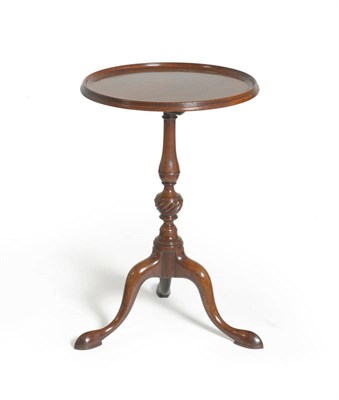 Lot 1311 - A George III Mahogany Tripod Table, late 18th century, the dished circular flip top raised on a...