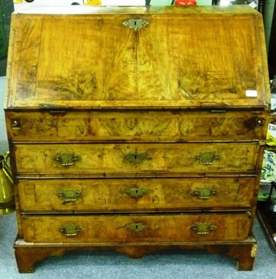 Lot 1313 - A Walnut and Feather Banded Bureau, the fall enclosing a fitted interior of pigeon holes,...