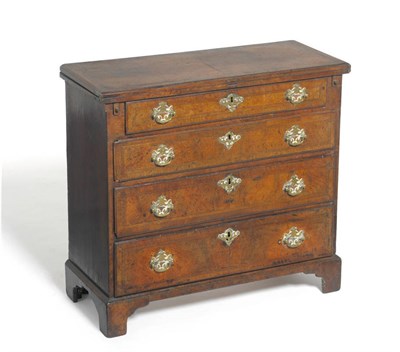 Lot 1314 - A George II Style Walnut and Feather Banded Bachelor's Chest, the hinged top above pull-out...