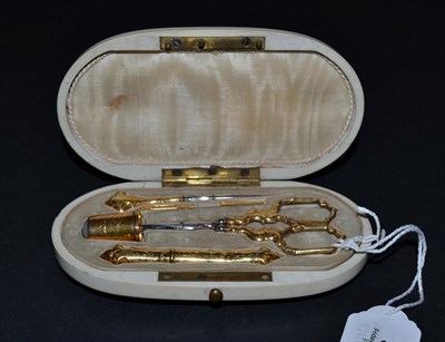 Lot 5324 - An 18ct Gold Sewing Set presented in an elegant oval ivory case, the lid lined in cream silk,...