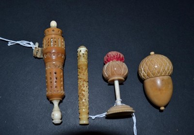 Lot 5334 - Four 19th Century Vegetable Ivory Sewing Items, to include a carved needle case, in the Chinese...