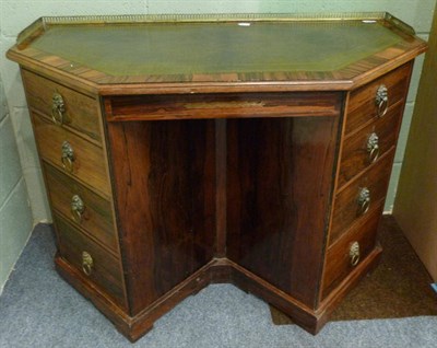 Lot 1319 - A Regency Style Rosewood Kneehole Desk, late 19th century, with three-quarter pierced brass gallery