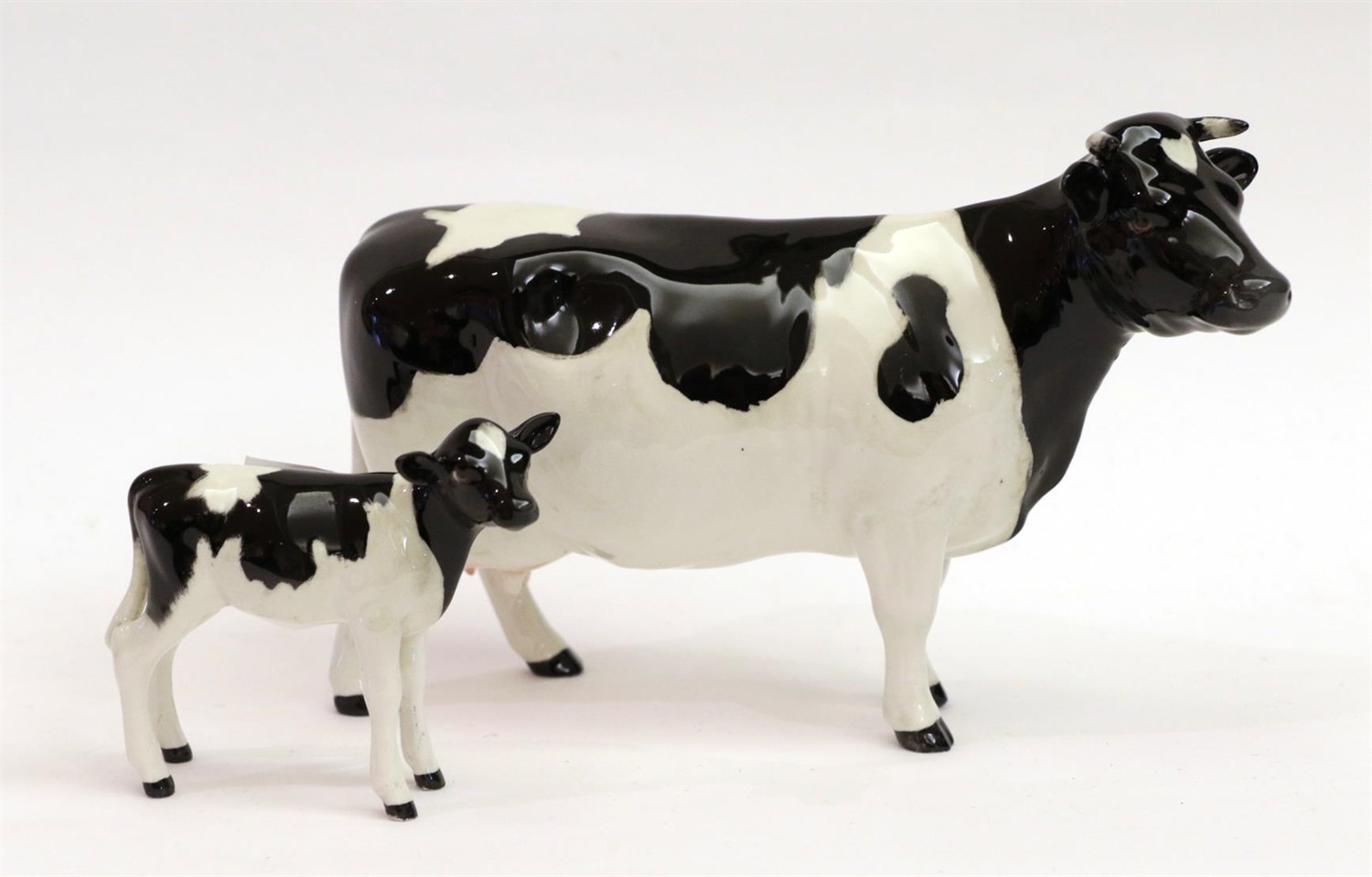 Lot 20 - Beswick Friesian Cow Ch. ''Claybury Leegwater'', model No. 1362A and Friesian Calf, model No....