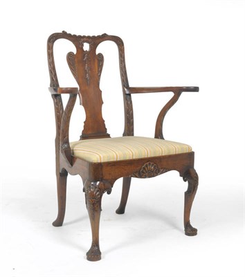 Lot 1334 - A George II Walnut Armchair, 2nd quarter 18th century, the carved top rail with flowerbell and leaf