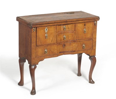 Lot 1339 - A Queen Anne Walnut Cross and Feather Banded Bachelor's Chest, the hinged top enclosing a...