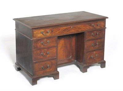 Lot 1341 - A George III Mahogany Kneehole Desk, late 18th century, the rectangular top above a fitted...