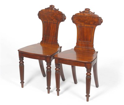 Lot 1350 - A Pair of Carved Mahogany Hall Chairs, 2nd quarter 19th century, the carved top rail with...