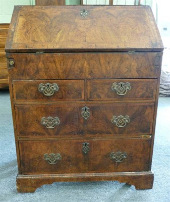 Lot 1363 - A Walnut and Herringbone Banded Bureau of Small Proportions, the fall enclosing a fitted...