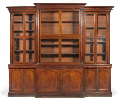 Lot 1365 - An Impressive Victorian Mahogany Breakfront Bookcase, late 19th century, the double cavetto cornice