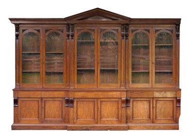 Lot 1373 - An Early Victorian Mahogany Breakfront Architectural Bookcase, circa 1850, with triangular...