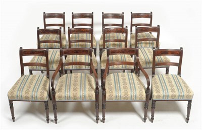 Lot 1386 - A Set of Twelve Mahogany and Brass Strung Dining Chairs, circa 1835, the curved top rail...