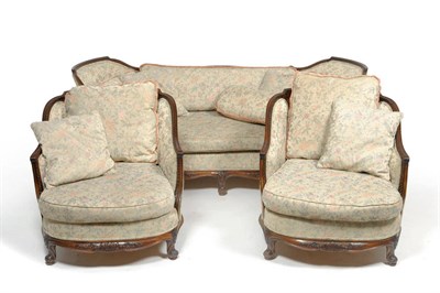 Lot 1389 - A Carved Walnut Three-Seater Settee, circa 1930, upholstered in modern light green and pink...