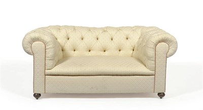 Lot 1395 - A Victorian Chesterfield Settee, late 19th century, upholstered in modern cream button back fabric