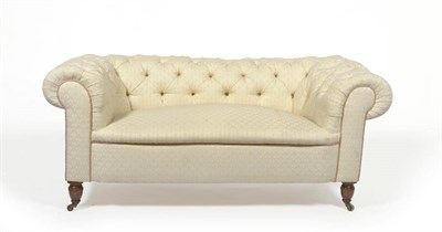 Lot 1396 - A Victorian Chesterfield Settee, late 19th century, upholstered in modern cream button back fabric