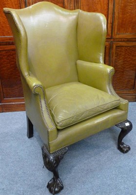 Lot 1398 - A George II Style Wing Back Chair, early 20th century, upholstered in olive green studded...