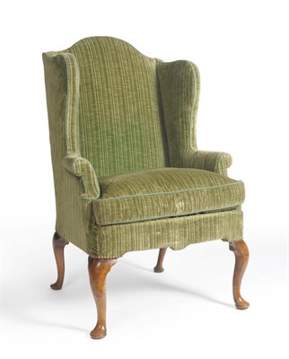 Lot 1402 - An Early Georgian Style Wing Back Chair, upholstered in modern green chenille, the rounded arm...