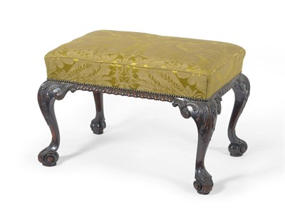 Lot 1408 - A George III Style Carved Mahogany Stool, late 19th century, upholstered in green floral silk...