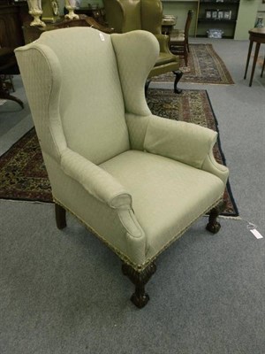 Lot 1409 - A Victorian Wing Armchair, with light green trellis upholstery and arm protectors, on front...